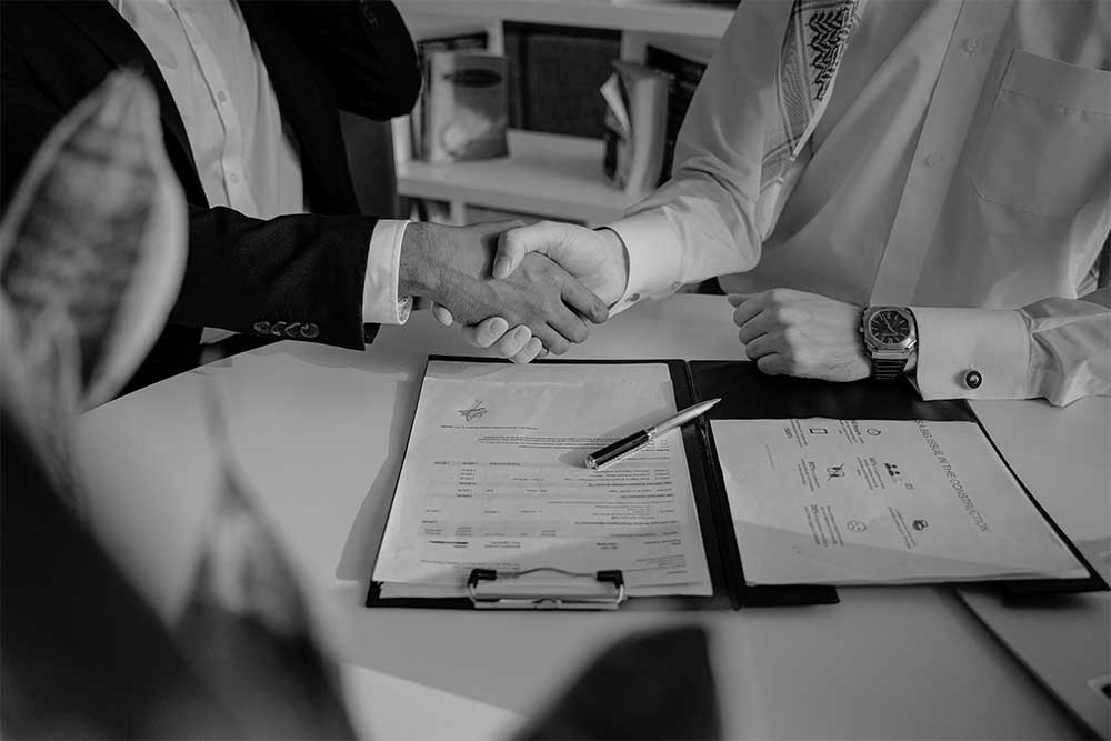 two people accepting a contract